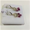 Image 2 : ONE PAIR OF 14KT YELLOW GOLD RUBY BRIOLETTE DANGLING EARRINGS. FLEUR DE LIS FRONT, AND A SCROLL AND