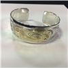 Image 1 : ONE HAND MADE 14K YELLOW GOLD AND STERLING SILVER FIRST NATIONS 1" BANGLE STYLE BRACELET. HAND