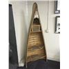 Image 1 : OLD NATIVE CANOE, REWORKED INTO AN UPRIGHT BOOKSHELF WITH SNOW SHOE SHELVES