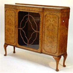 Burr walnut break front side cabinet fitted a cloud glazed door, flanked by a pair of cupboard do…