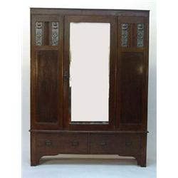 Art Nouveau oak and copper panelled wardrobe, fitted a centre mirrored door enclosing hanging spa…