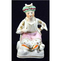 Hand painted Victorian porcelaineous seated Staffordshire gentleman with crossed legs, 13cm high…