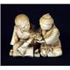 Image 1 : Carved ivory Japanese figure group of two seated children playing with a spinning top, 4cm in len…