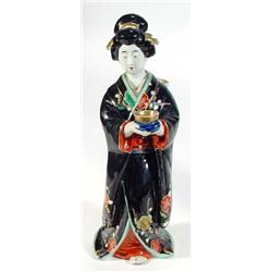 Hand painted porcelain  figurine of a Geisha girl clutching a bowl with outstretched arms, 33cm h…