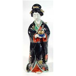 Hand painted porcelain  figurine of a Geisha girl clutching a bowl with outstretched arms, 33cm h…