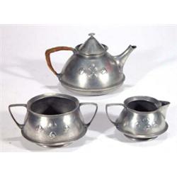 Liberty pewter three piece teaset with wicker handle, decorated with stylised scrolls, English pe…