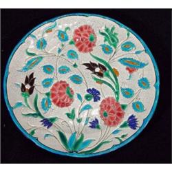 Longwy plate, hand decorated with pink and blue flowers onto a crackle glazed ground, 22cm diamet…