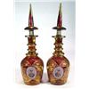 Image 1 : Two gilded and red stained glass decanters with two annulated neck rings, decorated with portrait…