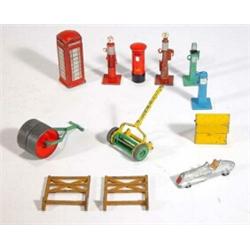 Dinky Toys red telephone box, grass roller, hand lawn mower, postbox, three petrol pumps, etc…