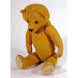 Old straw filled teddy bear with jointed limbs and glass eyes, 60cm high…