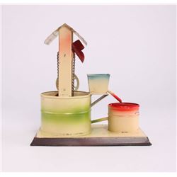 German made tin toy, of a bucket water well.  Marked
