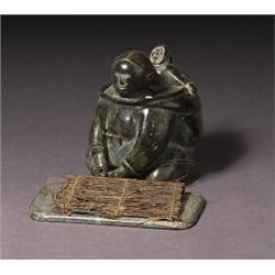 attributed to alacie alashuk, Povungnituk., Black stone carving of a mother carrying a child in...