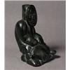 Image 1 : unidentified, Black stone carving of a man with fish, signed in syllabics to the underside and dat..
