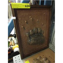 Cast model of a grizzly bear paw print