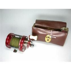 An Abu Ambassadeur No. 6000 multiplying reel in brown leather case with oil bottle and spares...