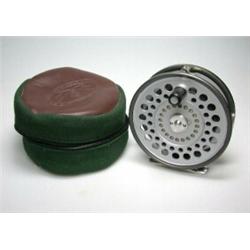 A Hardy St Aidan trout fly reel, grey finish, 35/8" in brown and green zip bag...