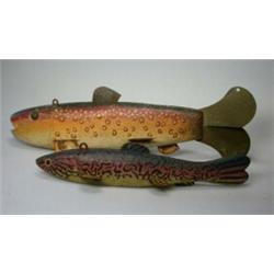 Two wooden decoys carved as fish, both painted and with metal fins, 29cm and 22cm respectively (2)..