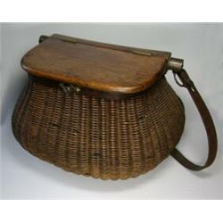 An old wicker creel with hinged wooden cover and leather strap...