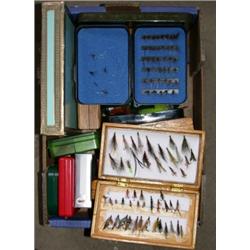 Sixteen plastic, wooden and other fly boxes containing a quantity of trout flies and lures (some bo.