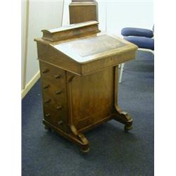 A FIGURED WALNUT DAVENPORT, mid Victorian, stringing inlay, four drawers to the right side, on ca...