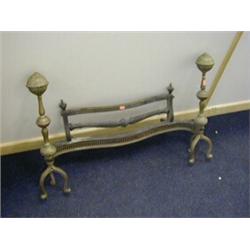 A BRASS FIRE GRATE, 19th Century, (front section only), fluted andirons on triple feet, serpentin...