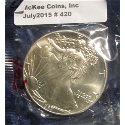 420. 1987 U.S. American Eagle One Troy Ounce Silver Dollar. Gem BU. In Littleton Cellophane.