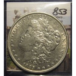 853. 1885 P Morgan Silver Dollar. EF 45. Scratches on reverse.