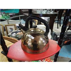 Whistling metal tea kettle