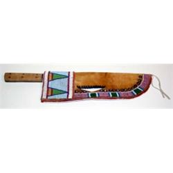 Crow Indian Beaded Rawhide Knife Case. 13" long. Estimate $750-$1,000.…
