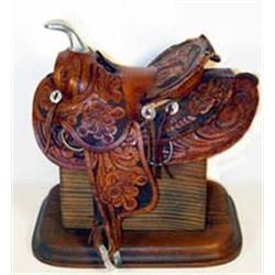 Salesman Sample Carved Saddle with stand. Estimate $125-$200.…