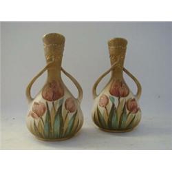 A PAIR OF ART NOUVEAU BOTTLE VASES, c.1900, tulip decoration on a blush drab ground, whip lash te...