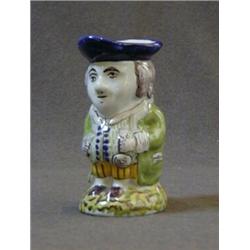 A FAIENCE TOBY JUG, continental, early 20th Century, wearing a blue hat and green jacket, height ...