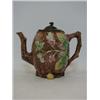Image 1 : A MAJOLICA TEAPOT, late 19th Century, moulded branches on a rustic bark textured ground, branch h...