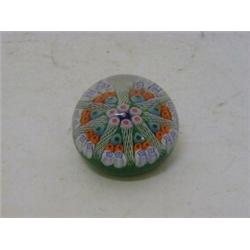 A MILLEFIORE GLASS PAPERWEIGHT, star shaped spiral cameo, orange and blue florals on a malachite ...