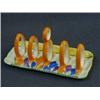 Image 1 : A CLARICE CLIFF BIZARRE TOAST RACK, Crocus pattern, five bars, length 17cm (s.d.)  £50-80...