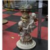 Image 1 : POLYRSEIN FIGUREINE GLASS TOP TABLE