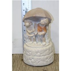 CONCRETE BOY AND GIRL UNDER UMBRELLA