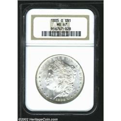 1885-O S$1 MS67 NGC. The upper right reverse has blushes of lemon and powder-blue patina. A lustrous