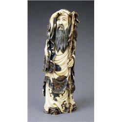 A Chinese polychrome decorated ivory figure of a bearded sage, - A Chinese polychrome decorated...