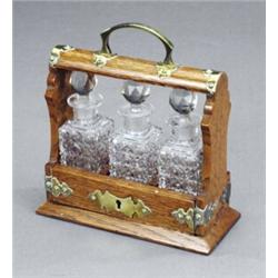 An Edwardian novelty three-bottle scent stand, - An Edwardian novelty three-bottle scent stand,...