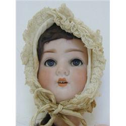 A SIMON & HALBIG DOLL HEAD, bonnet, brown wig, sleeping eyes, open mouth, nape marked 'P.B, 914/8...