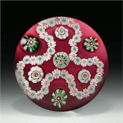 Antique Clichy trefoil garland paperweight, with a white millefiori garland, surrounding four sp...
