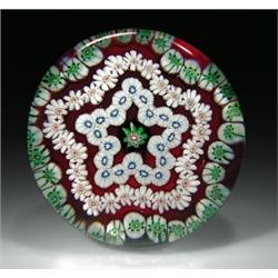 Antique Clichy star-shaped garlands paperweight, with a green, white, and pink central cane, sur...