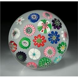 Antique Clichy spaced complex millefiori paperweight, with a central red pastry mold cane, encir...