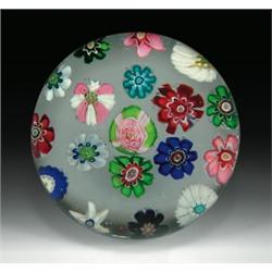 Antique Clichy spaced complex millefiori paperweight, with a central pink and green Clichy rose,...