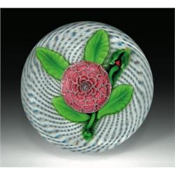 Antique Saint Louis pompon paperweight, with a pale pink flower, having a blue complex rod cane...