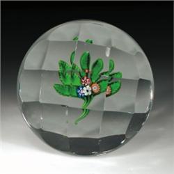 Antique Saint Louis faceted nosegay paperweight, with four cane flowers, five green leaves, and...