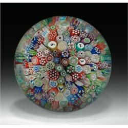 Antique Baccarat 1848 close packed complex millefiori paperweight, with Gridel silhouette canes...