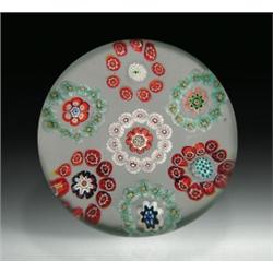 Antique Baccarat millefiori garlands paperweight, with seven circular garlands in red, white, an...