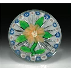 Antique Baccarat double clematis and garland paperweight, containing a pale, peach-colored flower...